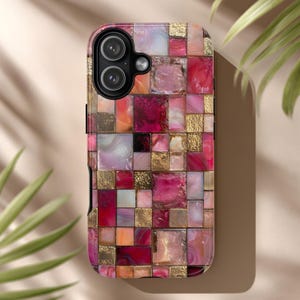 May include: A smartphone case with a mosaic design. The case features a pattern of squares in shades of pink, red, gold, and white. The camera lenses are visible at the top. The overall design is reminiscent of stained glass.