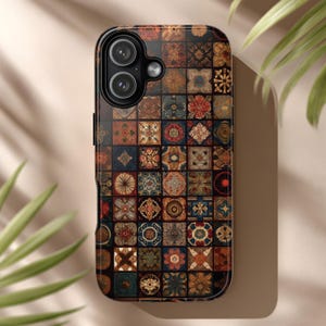 May include: A smartphone case with a mosaic tile design. The case features a pattern of small, square tiles in shades of brown, red, blue, and gold. The case has a black border and a camera cutout.
