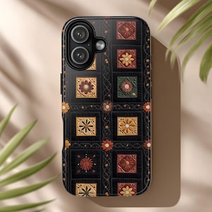 May include: Black phone case with a floral quilt design. The case features a repeating pattern of square blocks with various flower motifs in shades of yellow, orange, and red. The case has a glossy finish and a camera cutout.