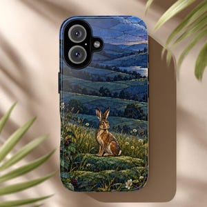 May include: A smartphone case featuring a detailed illustration of a brown hare sitting in a grassy meadow filled with small white flowers. The background depicts a rolling landscape of dark blue hills and fields under a twilight sky.