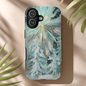 May include: A phone case featuring a winter forest scene with snow-covered trees and a geometric sunburst design in shades of teal, white, and gold. The case has a black border and a camera cutout.