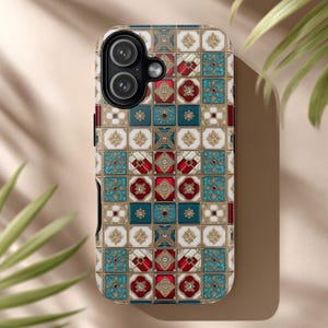 May include: A patterned phone case featuring a mosaic design with teal, red, white, and gold accents. The case has a square tile pattern with floral and geometric elements. The phone case is designed to fit a smartphone.