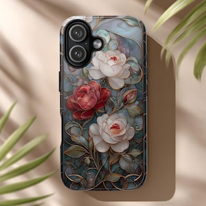 May include: A smartphone case featuring a floral design with red and white roses, green leaves, and a blue and teal background. The case has a glossy finish and a dark border, providing protection and style. The design resembles a stained-glass window.