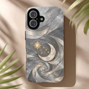 May include: A phone case featuring a gray and white marbled pattern with gold-toned lines forming swirling shapes. The design includes a central sun, a crescent moon, and four small stars, all rendered in a stained glass style with metallic accents.