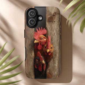 May include: A phone case featuring a detailed illustration of three chickens peeking out from behind a wooden fence. The chickens have red combs and wattles, with varying shades of brown and black feathers. The case has a black border and a camera cutout.