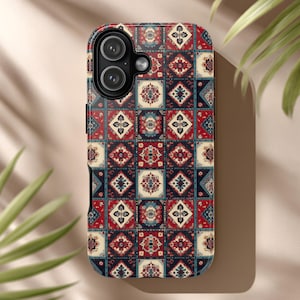 May include: A patterned phone case featuring a geometric design with red, blue, and cream-colored squares. The case has a camera cutout and a black frame. The design resembles a traditional rug pattern.