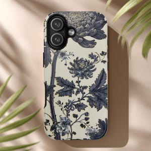 May include: A phone case featuring a floral design with large, stylized blue flowers and foliage against a cream background. The case has a glossy finish and a camera cutout.