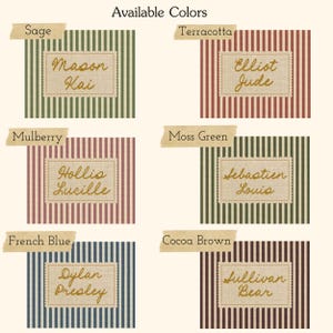 May include: A color chart displaying six striped fabric swatches labeled Sage, Terracotta, Mulberry, Moss Green, French Blue, and Cocoa Brown. Each swatch features a central rectangular patch with embroidered names: Mason Kai, Elliot Jude, Hollis Lucille, Sebastien Louis, Dylan Presley, and Sullivan Bear.