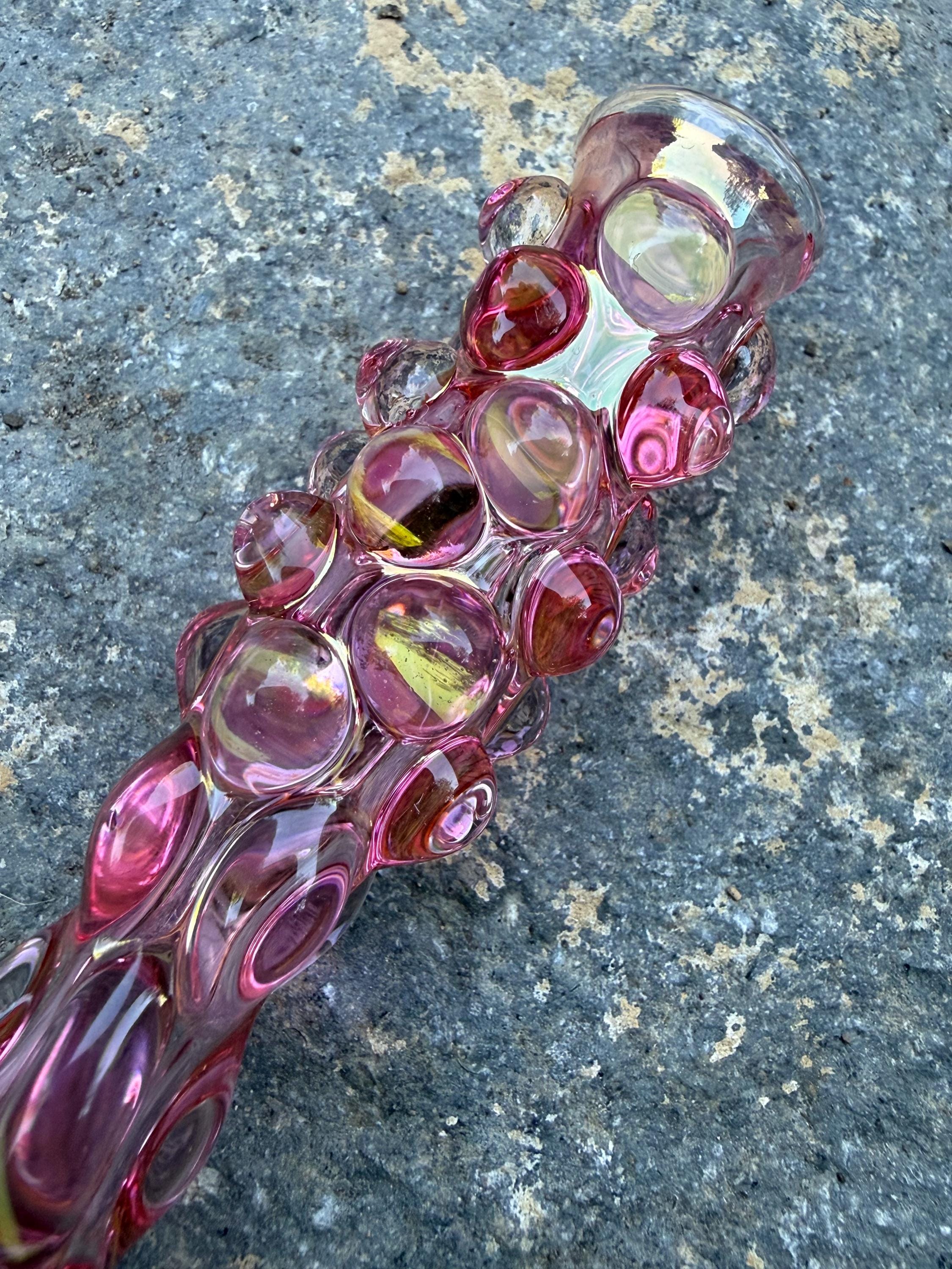 Grippy.  Fumed with fully with gold with clear magnifiers, glass pipe chillum.  Will color in.        Made in USA