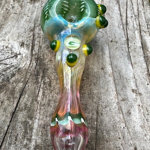 Decorated  green and yellow green G glass pipe.  Fumed with silver and gold. Made in USA