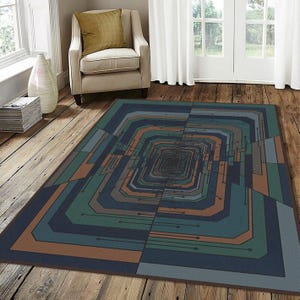 May include: Geometric patterned area rug in shades of blue, green, and brown. The rug features a repeating rectangular design that creates a tunnel-like effect. The rug is placed on a wooden floor.