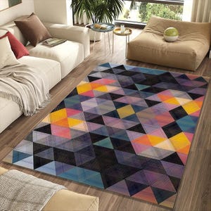 May include: A large area rug with a geometric pattern of colorful triangles in shades of blue, purple, yellow, and orange. The rug is rectangular and placed on a hardwood floor, adding a vibrant touch to the room's decor.