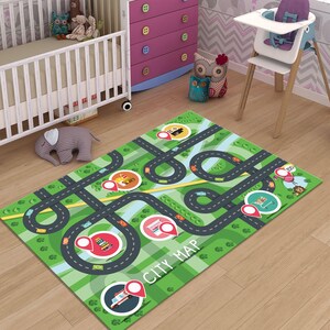 May include: A rectangular green play mat with a city map design. The mat features roads, buildings, and vehicles. The words "CITY MAP" are printed on the mat. The mat is designed for children's play.