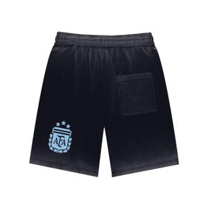 May include: Dark grey shorts with a light blue emblem featuring three stars and the letters "AFA". The shorts have a drawstring waist and a single back pocket. The fabric has a faded, vintage appearance.