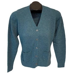 May include: Teal-colored cardigan sweater with a V-neck, long sleeves, and two front pockets. The sweater has a button-up closure with four buttons. The material appears to be a soft knit.