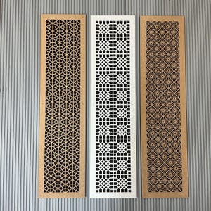 May include: Three rectangular decorative panels with intricate geometric cut-out patterns. One panel is light brown, one is white, and the third is a darker brown. The panels are designed for architectural or decorative use.