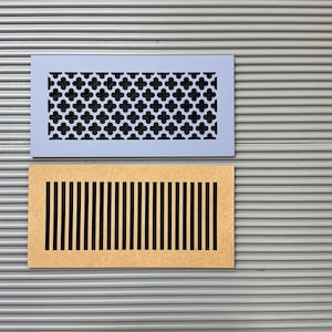 May include: Two rectangular air vent covers. One is light blue with a black quatrefoil pattern. The other is a natural wood color with vertical black slits. Both are set against a gray, corrugated background.