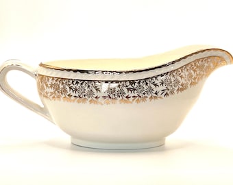 Salsera vintage de cerámica Portland, estilo Staffordshire, con diseño floral dorado, fabricada en Inglaterra alrededor de 1950.