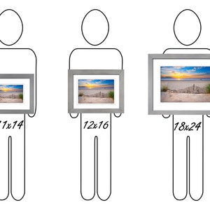 May include: Three different sizes of framed artwork, showing a beach scene with a wooden fence and a sunrise. The frames are gray and the artwork is printed on paper. The sizes are 11x14 inches, 12x16 inches, and 18x24 inches.