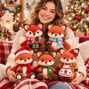 May include: Five knitted fox plush toys with festive accessories. One wears a red Santa hat and scarf, one has a red and white striped scarf with a gift, one wears a blue snowflake scarf, one has reindeer antlers and a green scarf, and one wears an apron with a gingerbread man.