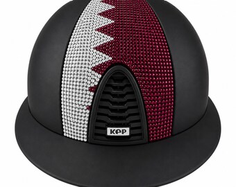 May include: A matte black equestrian helmet featuring a central panel decorated with white and maroon crystals arranged in a serrated pattern. The helmet includes a black front ventilation grill with the white text KEP printed on a small rectangular label.