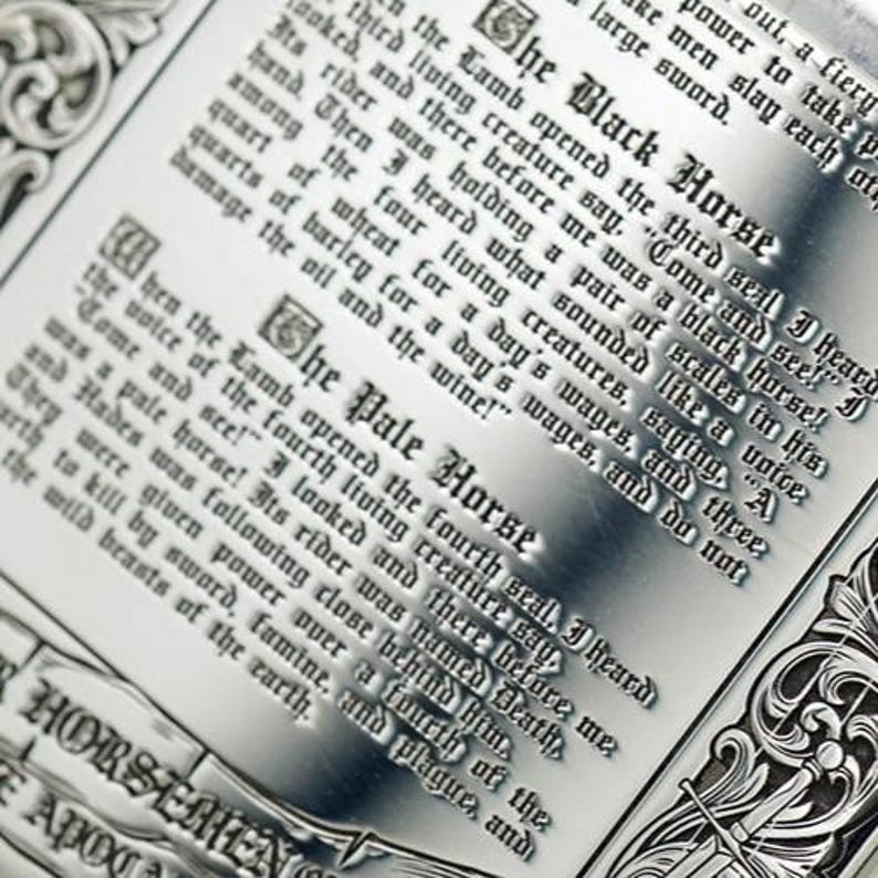 May include: Close-up of a metal plaque with engraved text. The text includes phrases like "The Black Horse" and "The Pale Horse." The design features ornate borders and gothic-style lettering, evoking a historical or fantasy theme.