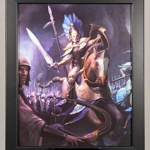 May include: Framed artwork depicting a warrior on horseback, clad in gold armor and wielding a sword and spear. The warrior is in a battle scene with other soldiers. The artwork is framed in a black frame.