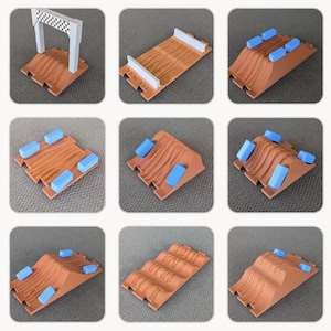 May include: A collection of nine modular toy track segments in a terracotta color with textured surfaces. The set includes a checkered finish line arch, flat track pieces, and ramps, some featuring removable light blue rectangular block obstacles.
