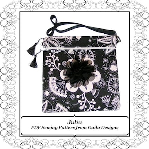 May include: A black and white patterned crossbody bag with a black flower. It features a long black strap, a white zip, and black tassels. The text reads "Julia PDF Sewing Pattern from Gaila Designs".