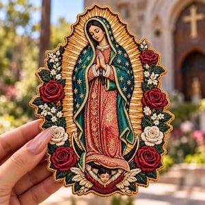 May include: An embroidered patch featuring the Virgin of Guadalupe with a teal mantle, red dress, and gold star accents. The figure is surrounded by a border of red and white roses, green leaves, and a winged angel at the base.