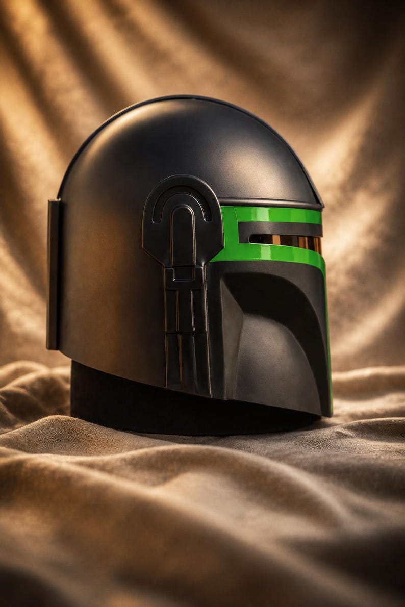 May include: A matte black helmet featuring a distinct T-shaped visor area accented with a vibrant green stripe. The helmet has a smooth, rounded dome and a structured side panel design with a vertical rectangular detail on the back section.