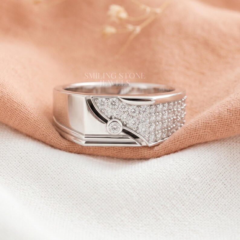 Modern Men's Wedding Band in 14k Gold featuring Lab Diamond pave rows. Sustainable luxury jewelry for the modern groom. Personalized custom engagement ring with white gold finish.