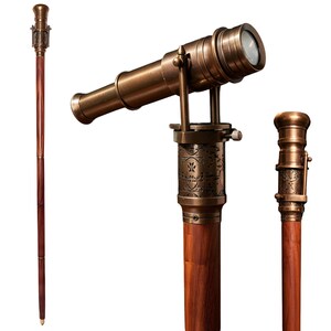 May include: A vintage-style walking cane with a telescope design. The cane features a dark brown wooden shaft and a bronze-colored telescope mounted on top. The telescope is detailed with intricate designs and a lens. The cane is a decorative item.
