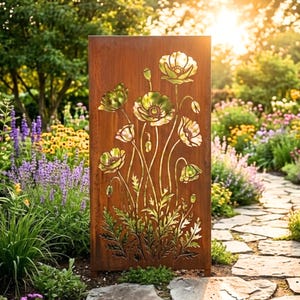 May include: A rectangular, weathered metal garden screen featuring a cut-out design of poppy flowers and foliage. The poppies are in shades of green and white, set against a rusty brown background. The screen is placed in a garden setting.
