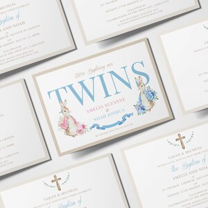 Puede incluir: Una invitaci&oacute;n de bautismo con fondo azul claro y blanco. La invitaci&oacute;n presenta una cruz con hojas verdes, una ilustraci&oacute;n de acuarela de dos conejos y el texto "We're Baptizing our TWINS Amelia Suzanne & Noah Joshua".
