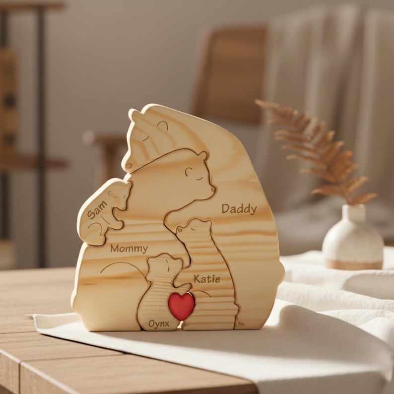 Puede incluir: Rompecabezas familiar de osos de madera con los nombres "Sam", "Mommy", "Daddy", "Katie" y "Oynx" grabados. Un coraz&oacute;n rojo est&aacute; tallado en el rompecabezas. El rompecabezas est&aacute; hecho de madera clara y est&aacute; dise&ntilde;ado para entrelazarse.