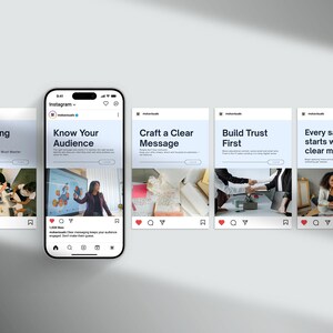 May include: A smartphone displays an Instagram feed with four posts about marketing. The posts feature text like "Marketing Basics" and "Know Your Audience." Each post includes an image and a caption. The phone is on a light gray surface.