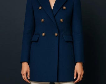 May include: A navy blue double-breasted coat with gold-colored buttons. The coat has a classic design with a notched collar and two front pockets. The model is wearing beige pants.