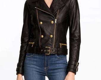 May include: Black leather jacket with gold-tone hardware, including a double-breasted front with round buttons, a belted waist, and zippered pockets. The jacket features a classic biker style with notched lapels and cuff details.