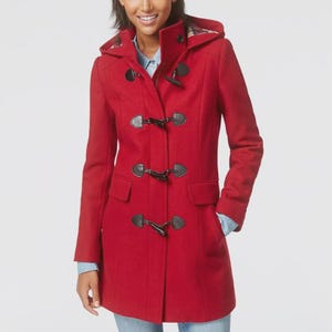 May include: A red toggle coat with a hood. The coat features black toggle closures and two front pockets. The hood lining has a plaid pattern. The coat is a classic style, suitable for cooler weather.