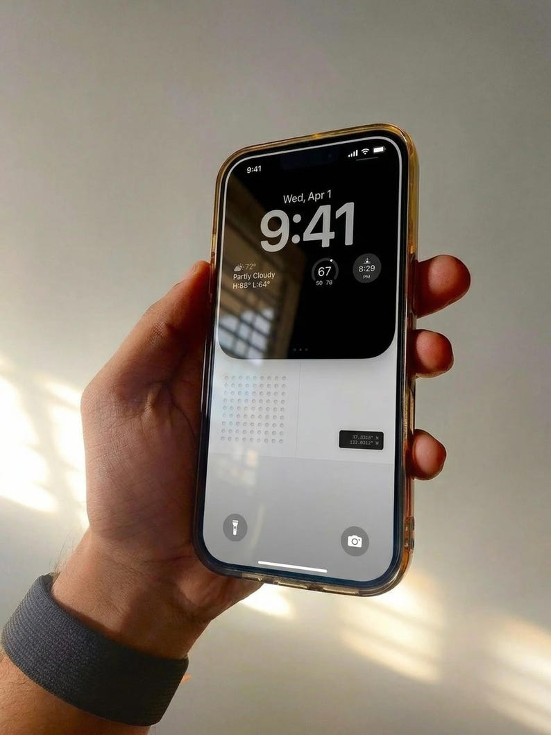 May include: A smartphone with a clear case is held in a hand. The screen displays the time as 9:41 AM, the date, and weather information. The phone has a gold-colored border.