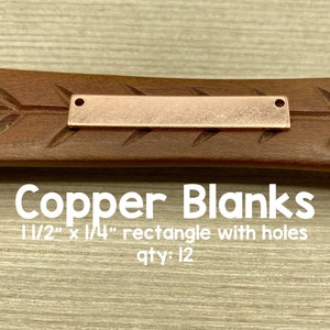 May include: Copper blanks for jewelry making. 12 pieces, 1 1/2 inches by 1/4 inch, with holes.  Rectangle shape.