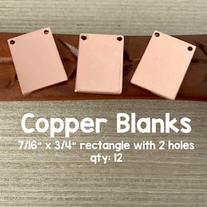 May include: Three copper rectangle blanks with two holes each. The blanks are 7/16 inches by 3/4 inches. The text "Copper Blanks" is written in white letters on a brown wooden surface. The text "7/16" x 3/4" rectangle with 2 holes" is written in white letters below the title. The text "qty: 12" is written in white letters below the dimensions. The text "Avalon Beads" is written in white letters in the bottom right corner of the image.