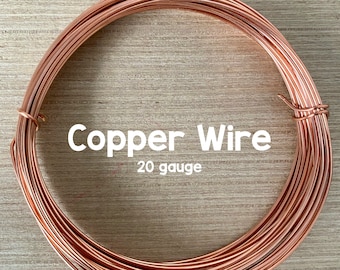 May include: A coil of copper wire, 20 gauge, on a wooden surface. The wire is a warm copper color.