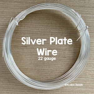 May include: A roll of silver plated wire, 22 gauge. The wire is coiled and ready to be used for jewelry making or other crafts.