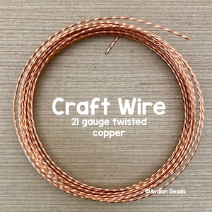 May include: A close-up of a spool of 21 gauge twisted copper craft wire. The wire is a warm copper color and has a slightly textured finish.