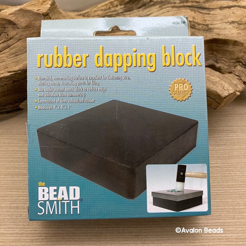 May include: A black rubber dapping block in a box. The box reads "rubber dapping block" and "the BEAD SMITH". The block measures 10.16cm x 10.16cm x 2.54cm and is for flattening wire and chasing metal.