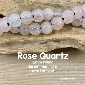 May include: A strand of 12mm round rose quartz beads with a large 4mm hole. The beads are a pale pink colour and have a natural, slightly cloudy appearance.  Rose Quartz 12mm round large 4mm hole qty: 1 strand @Avalon Beads