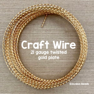 May include: A close-up of a spool of gold-plated twisted craft wire. The wire is 21 gauge and is ideal for jewelry making and other crafts.