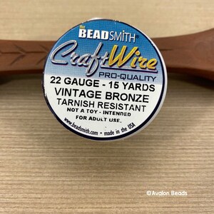 May include: A spool of 22 gauge, 15 yard vintage bronze CraftWire, tarnish resistant, made in the USA.  The spool is labeled "The Beadsmith Pro-Quality CraftWire".